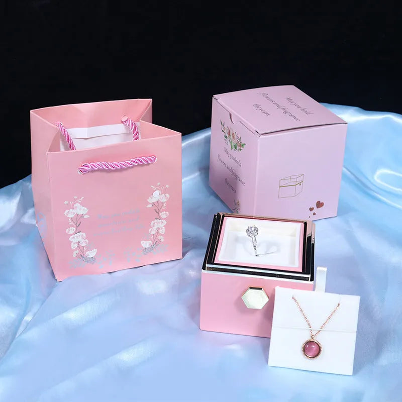 Rotating rose jewellery gift box with acrylic transparent cover showing preserved rose and rotating drawer open.