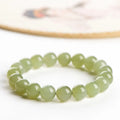Polished Hetian jade bead bracelet in clear water colours on a wrist, showing bead size options.