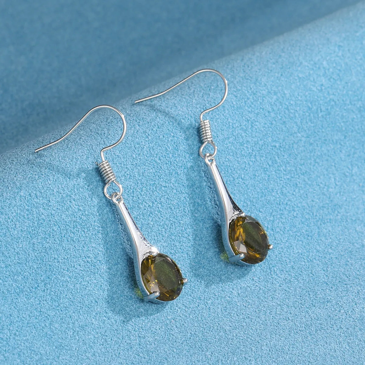 Olive green retro-style drop earrings with a minimalist water drop shape on a white background.