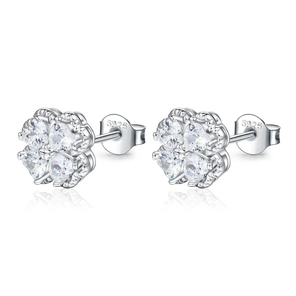 A pair of 925 silver earrings with a four-leaf clover charm and heart-shaped zircon stones in white gold colour.