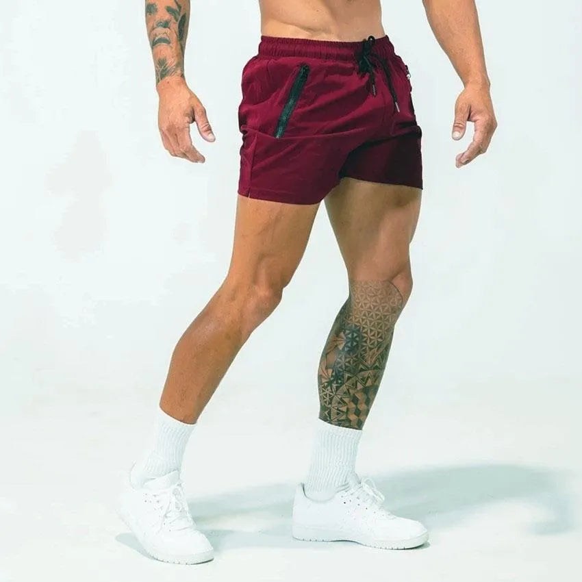 Man wearing blue mid-waist polyester sports shorts on a casual summer day.