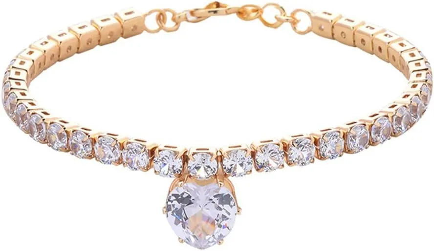 Gold heart-shaped rhinestone dog collar on a white background, showing shiny crystals and adjustable clasp.
