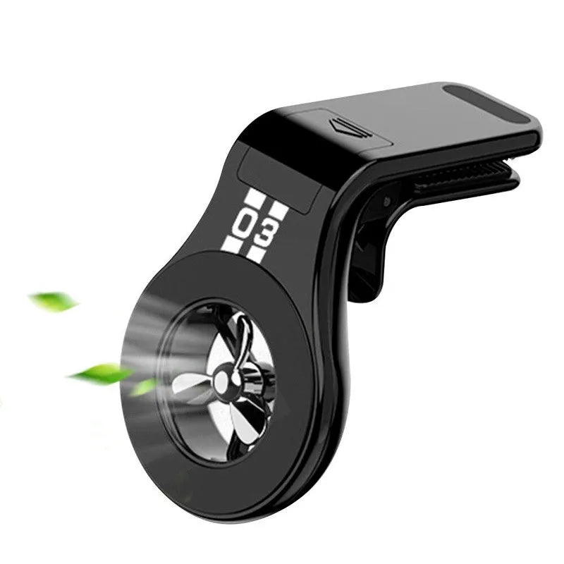 Black magnetic car air vent phone holder with adjustable head and fragrance slices attached to a vehicle vent.
