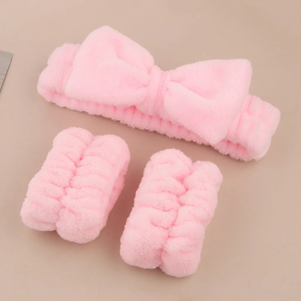 Purple gradient facial brush and matching coral fleece absorbent hair band set on a white background.