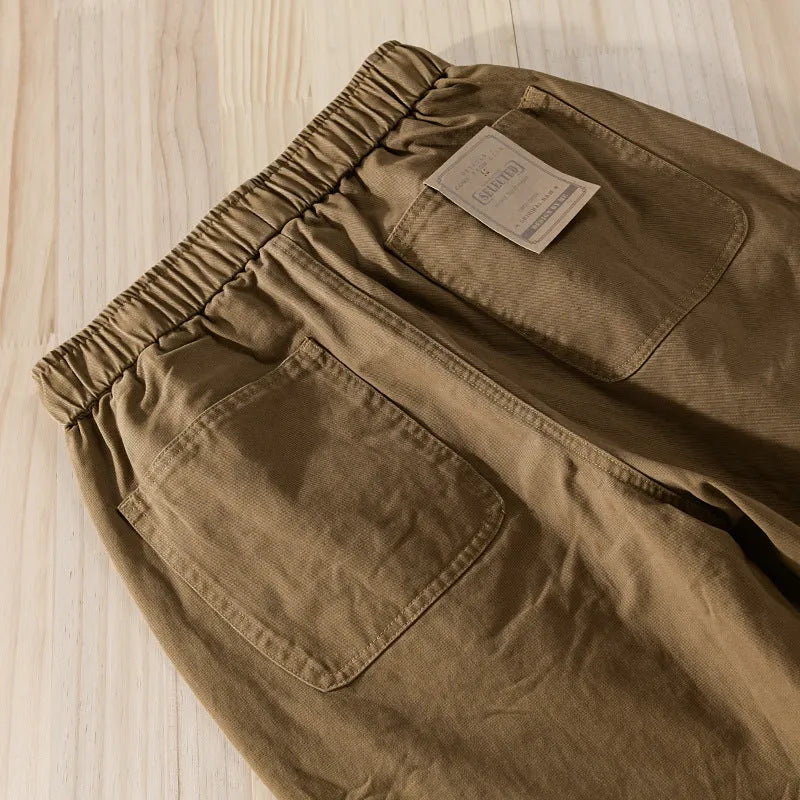 Men's cotton casual overalls in army green with a drawstring waist and tapered ankle bands.