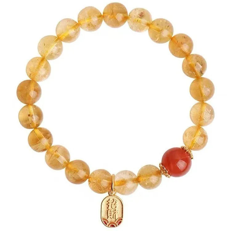 Natural red agate bracelet with gold-tone setting showing polished gemstone beads