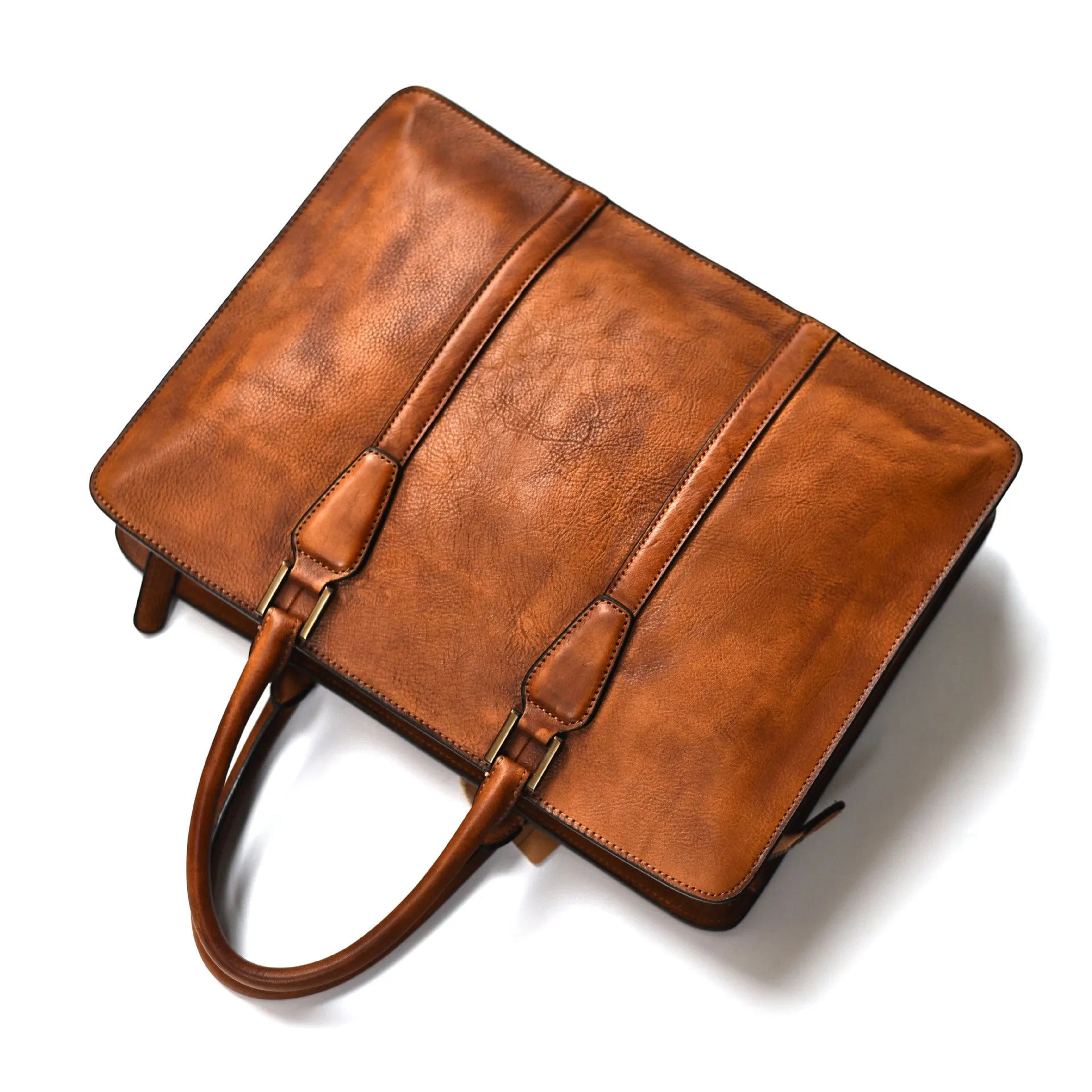 Men's brown leather retro style horizontal handbag with zipper, shown next to a 14-inch laptop for scale.