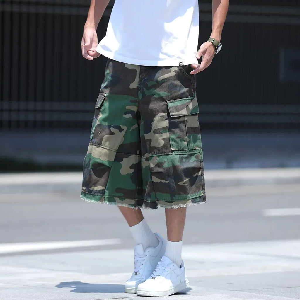 Man wearing loose fit camouflage retro workwear shorts in a khaki camouflage pattern.
