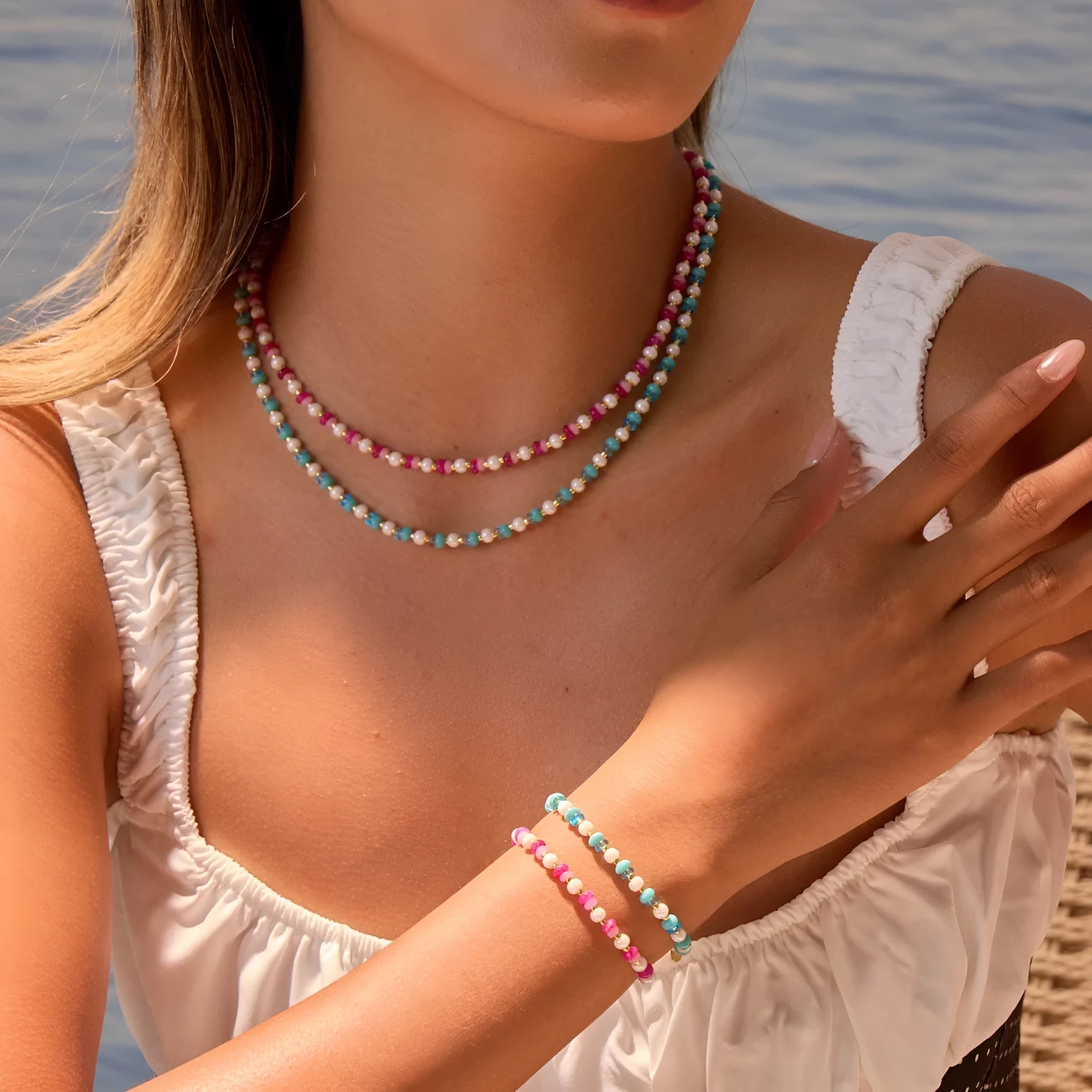 Sweet resin beaded necklace with geometric 18K stainless steel pendant, pink beads, and regular chain on light background