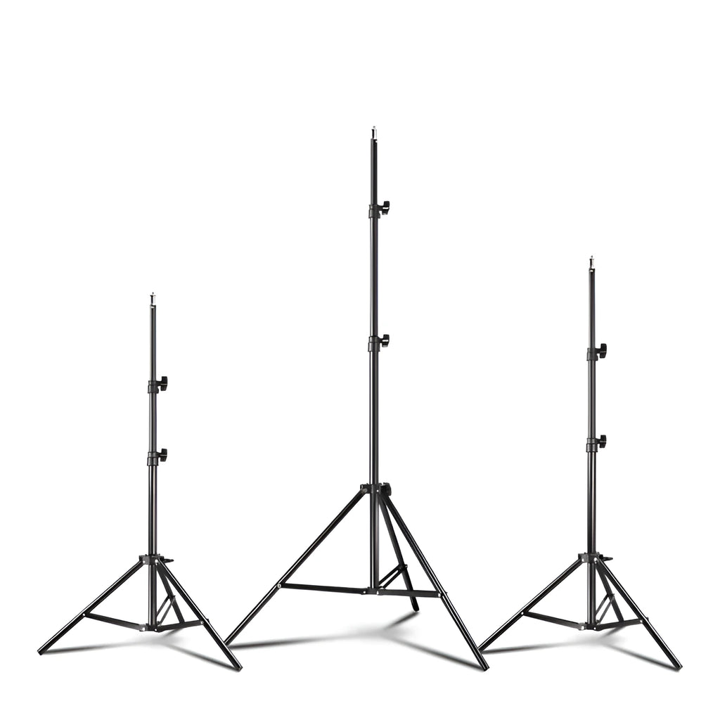 Black mobile phone tripod extended to 1.1m on a desk showing metal legs and phone mount