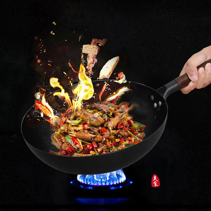 Black traditional iron wok pan with wooden handle and induction base