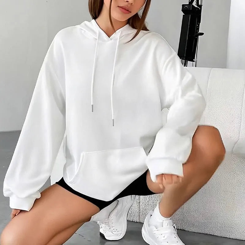 Women's loose fit grey sweatshirt with a drawstring pocket and long sleeves on a hanger.