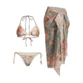 Women's creamy white floral bikini set with top, briefs, and removable skirt on beach background