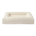 Beige rectangular cloth dog bed shown in medium size on a floor.