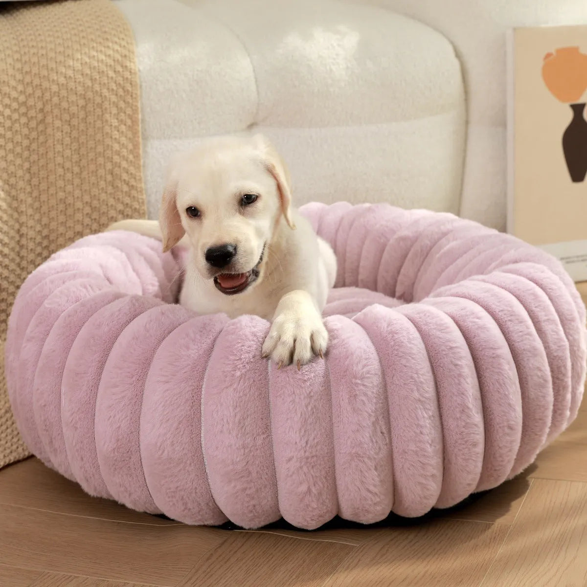 Round plush pet nest mat in beige, shown with a cat curled up inside.