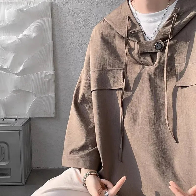 Men's grey hooded short sleeve t-shirt showing loose fit pullover design