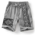 Man wearing blue colour block digital print casual shorts with a lace-up drawstring waist.