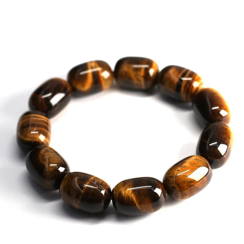 Yellow Tiger's Eye gemstone beaded bracelet with ethnic styling on a wrist.