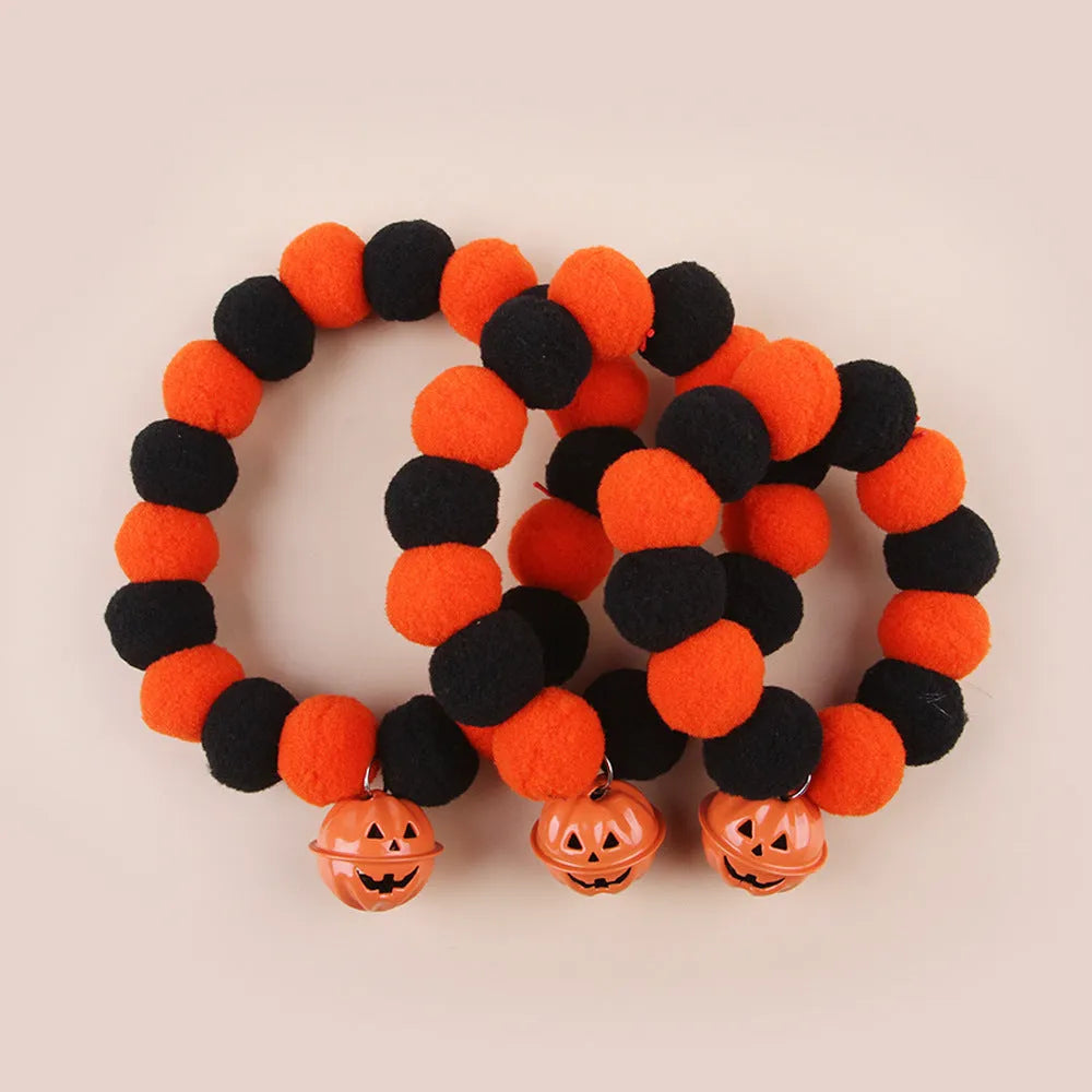 Orange pumpkin-patterned adjustable cat collar for Halloween worn by a cat.