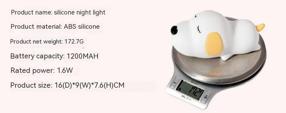 Cute two-colour silicone cartoon dog USB rechargeable night lamp on a surface.