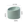 A dark green ceramic elevated cat bowl showing its raised height and round, whisker-friendly shape.