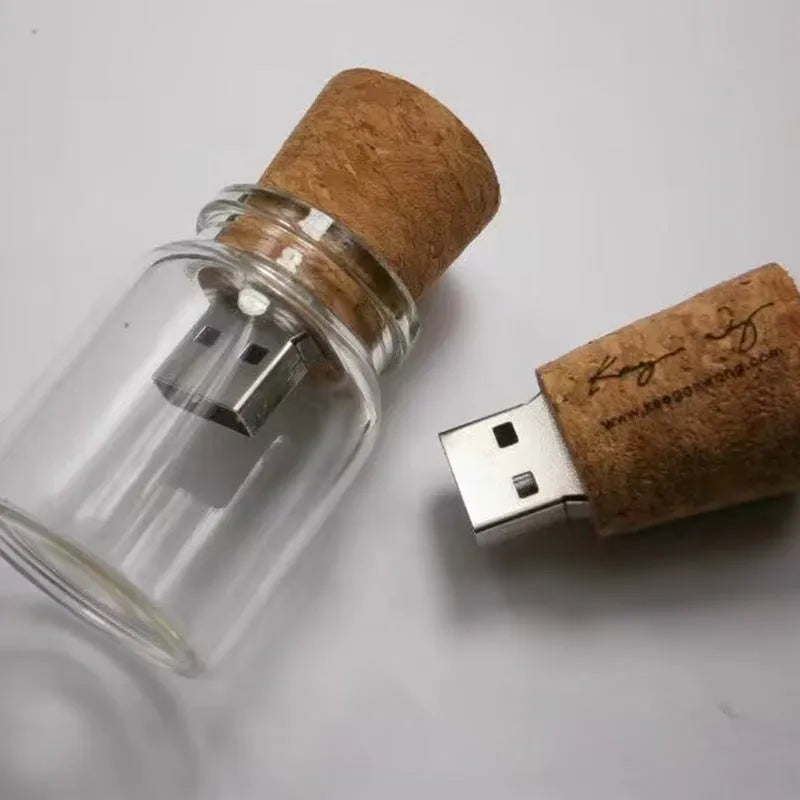 Transparent bottle-shaped USB flash drive on a wooden surface.