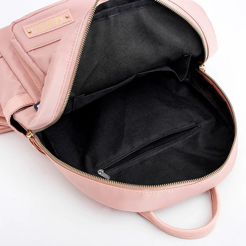 Men's black nylon casual backpack with double straps, a soft handle, and external pocket.