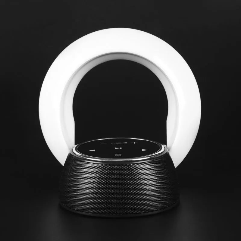 Blue and white Bluetooth speaker desk lamp with touch controls and foldable arms on wooden desk