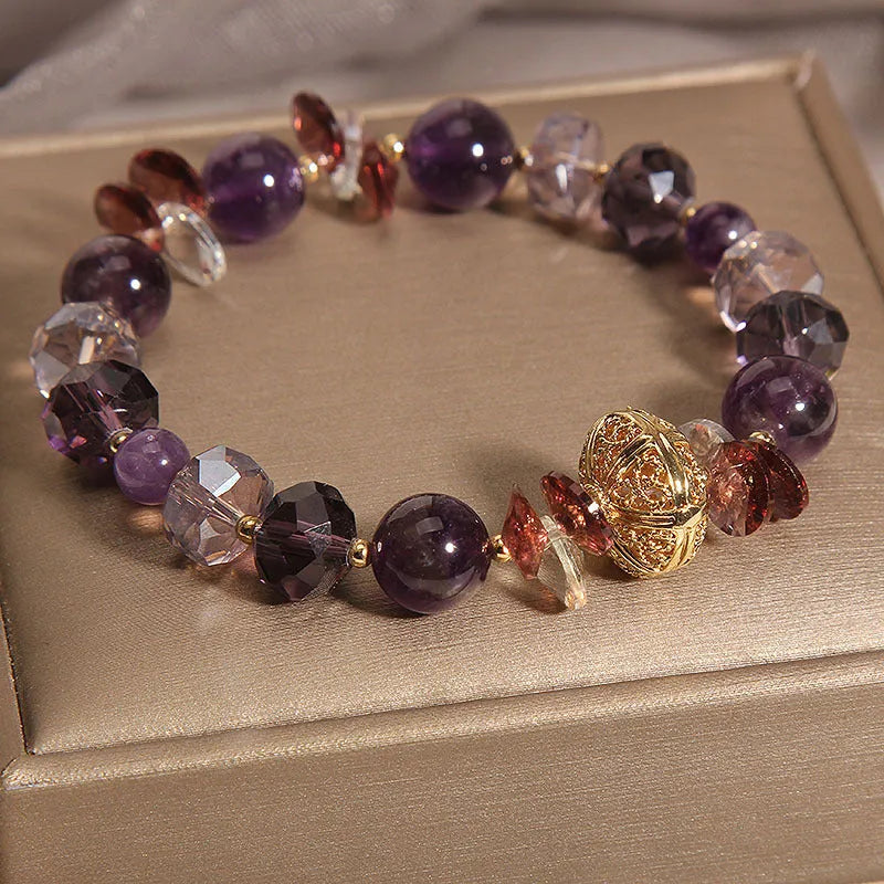 Purple crystal bracelet with pumpkin beads, wind chime motifs, and rhinestone decorations on adjustable band