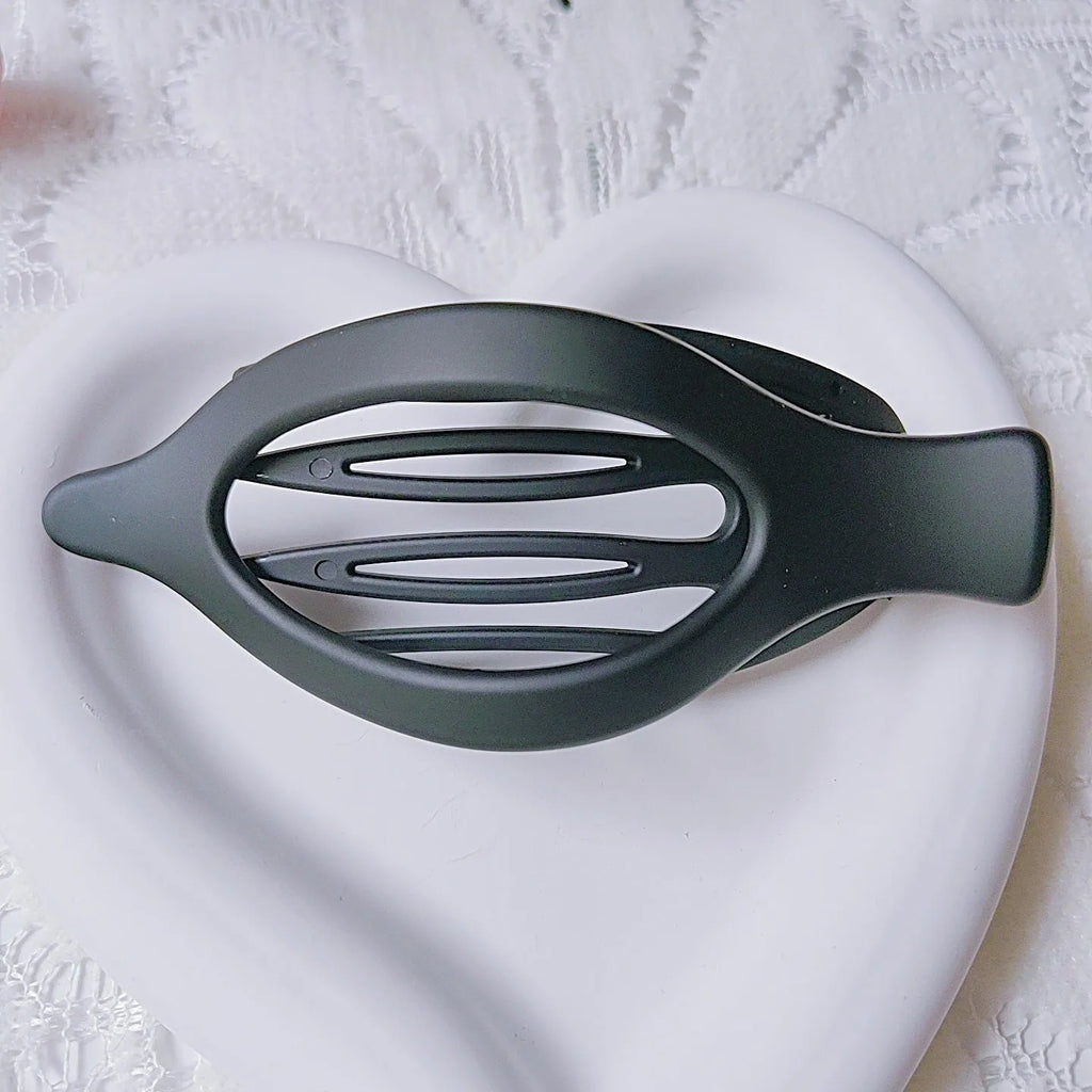 Six nude-coloured plastic hair clips with frosted grip and pointed toe design arranged on white background