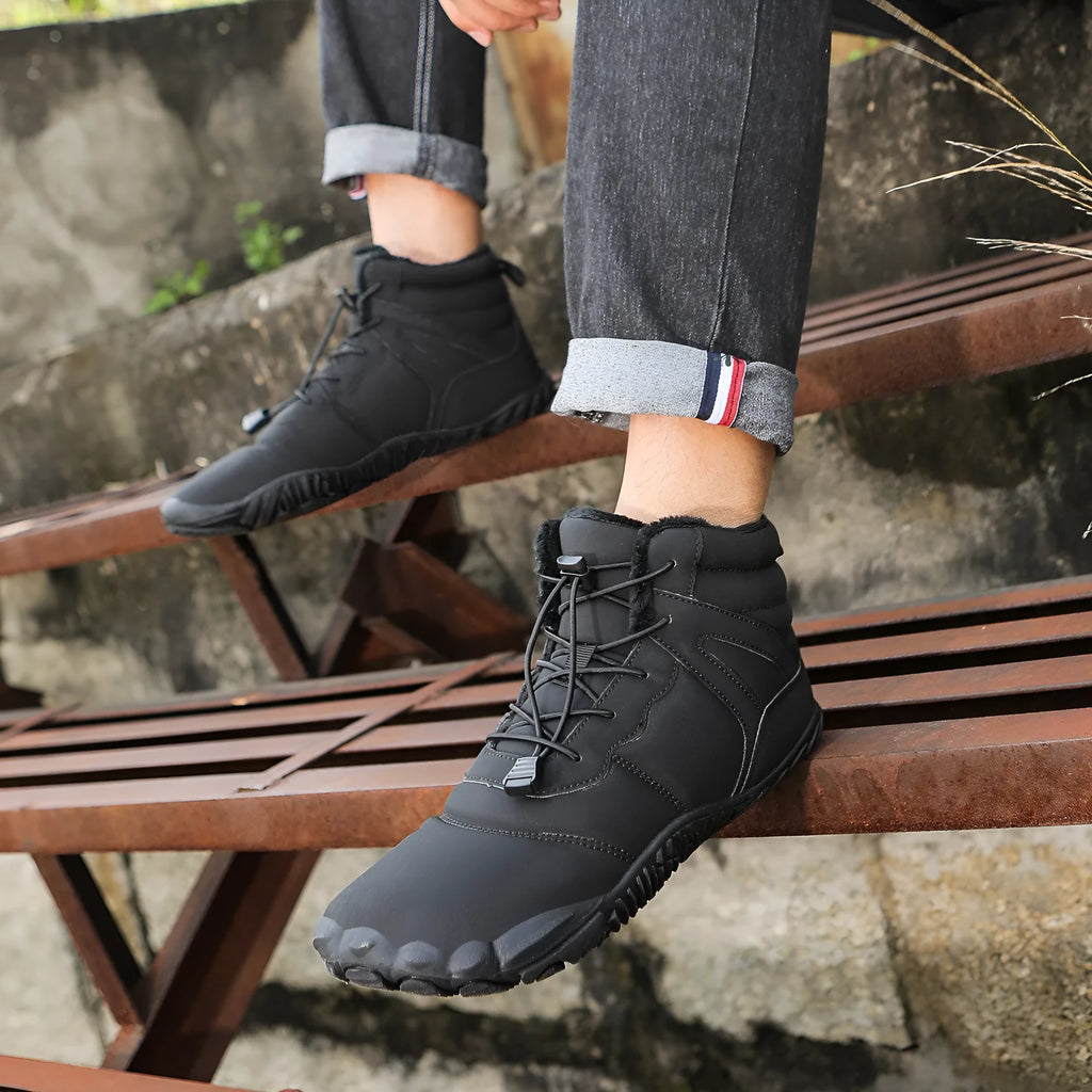 Beige five-finger waterproof snow boots with rubber sole and fleece lining on outdoor ground.