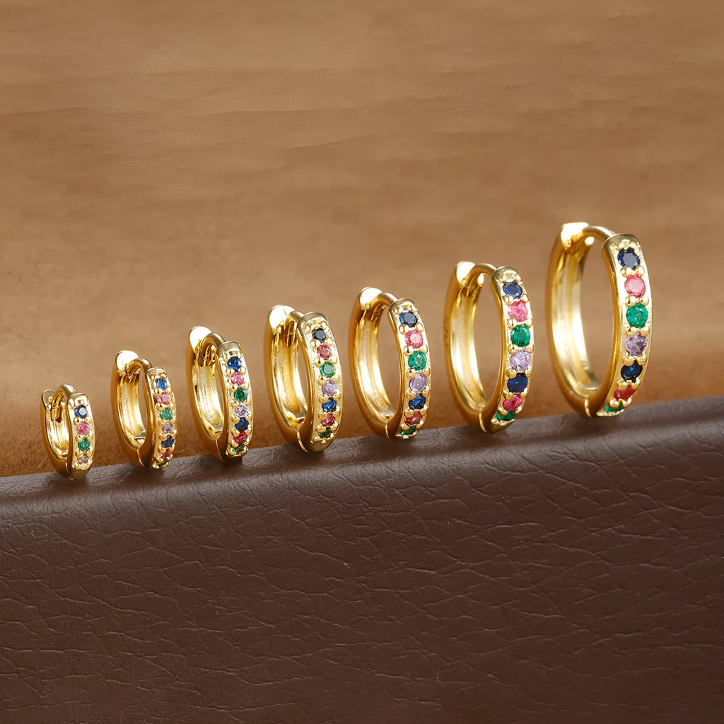 Geometric circle shape zircon perforated stud earrings in gold, rose gold, and silver colour on a white background.