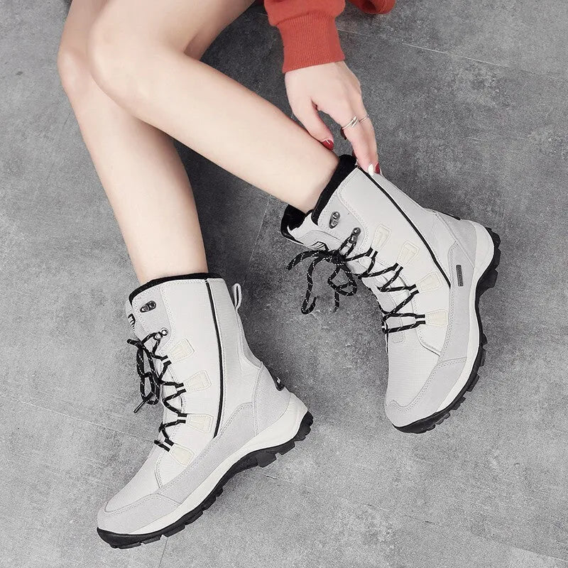 Women's black mid-calf length genuine leather snow boots with a round toe and rubber sole.
