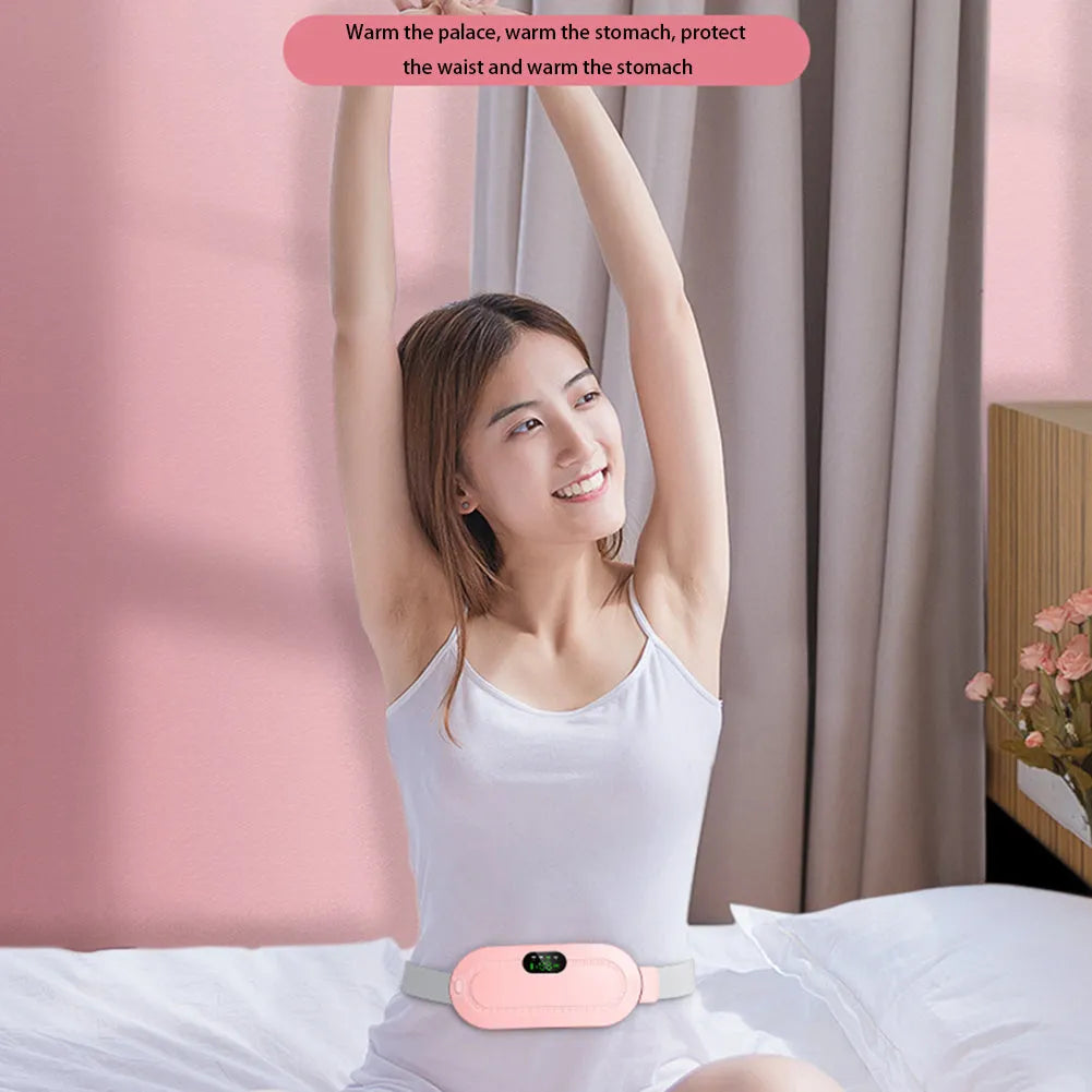 Pink menstrual heating pad with controller displaying temperature settings and vibration options