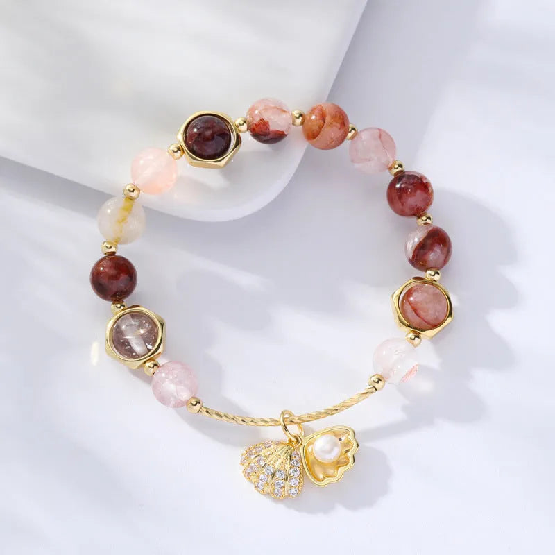 Colourful crystal shell bracelet with hair crystal detailing and red sealant flower shell accents