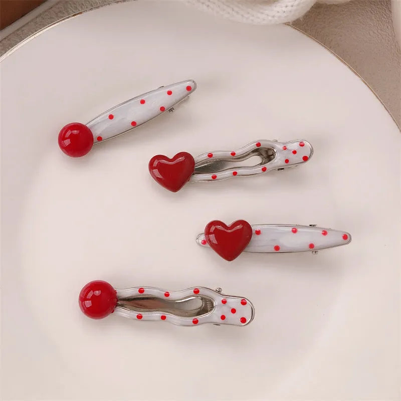 Red love heart shaped barrette hair clip with retro white dot design on black background