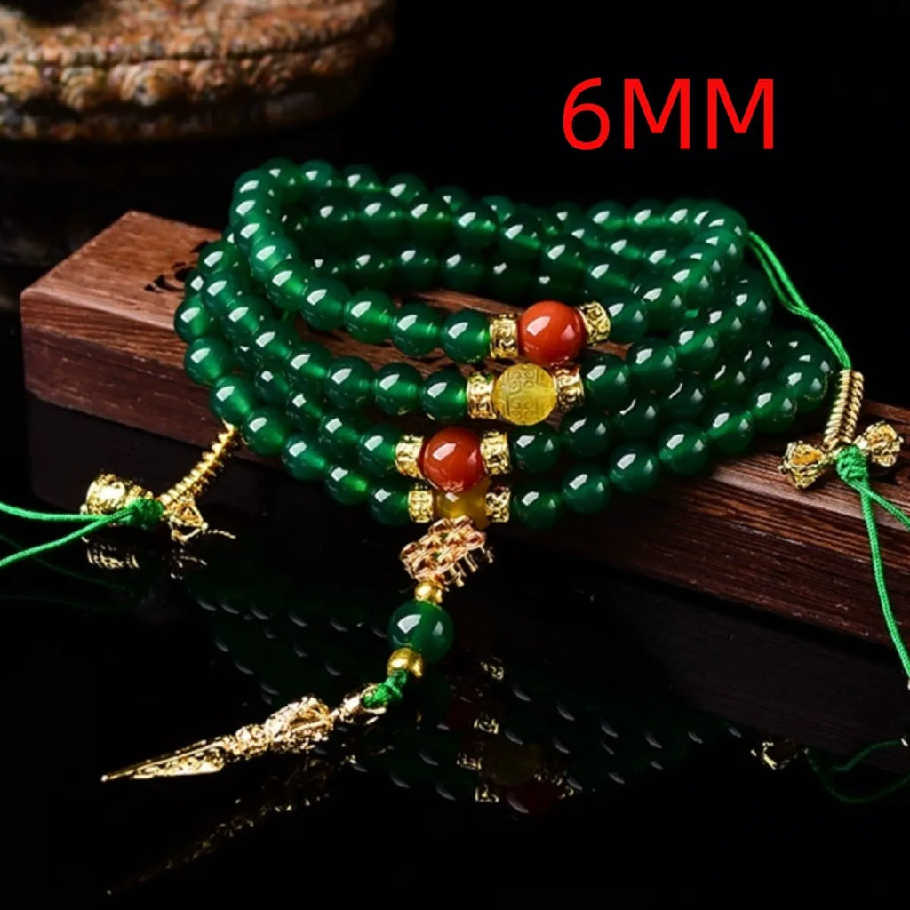 Close-up of a multi-circle green agate bracelet with natural stone beads on a wrist.