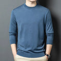 Man wearing a round neck, long sleeve wool and mulberry silk sweater in a neutral colour.