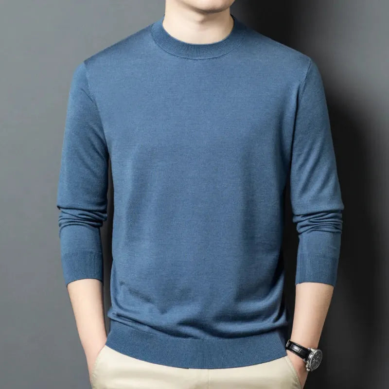 Man wearing a round neck, long sleeve wool and mulberry silk sweater in a neutral colour.