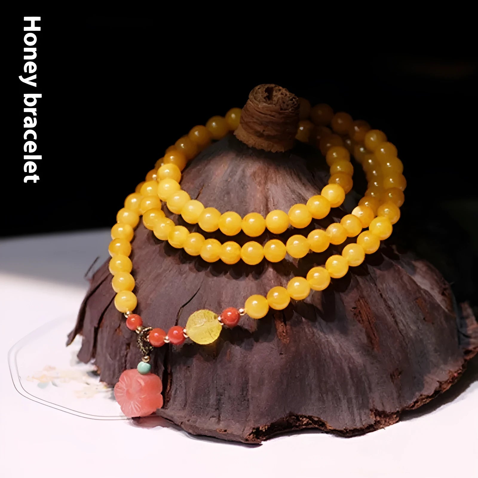 Yellow amber bracelet with 5mm round beads and an animal zodiac charm on a white background.