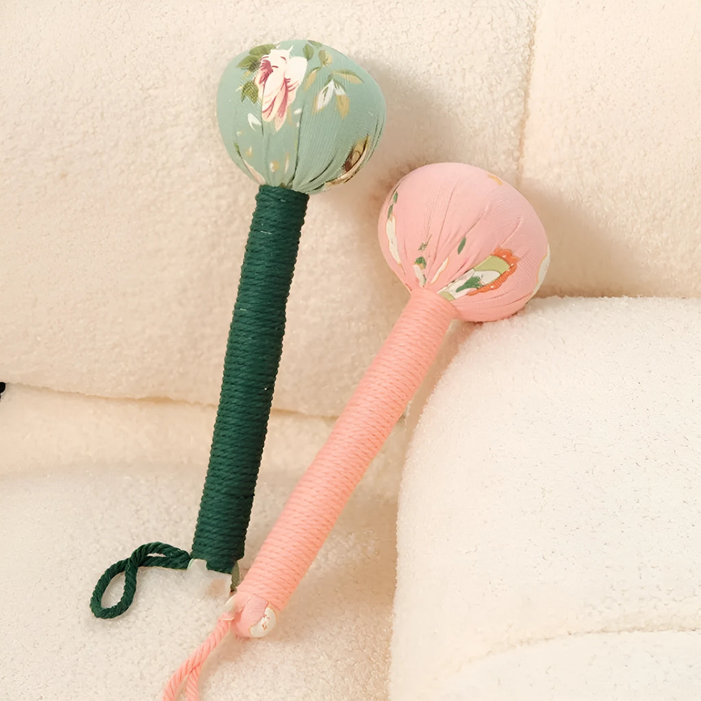 Argy wormwood hand-held massage hammer in green colour on a 26cm scale.