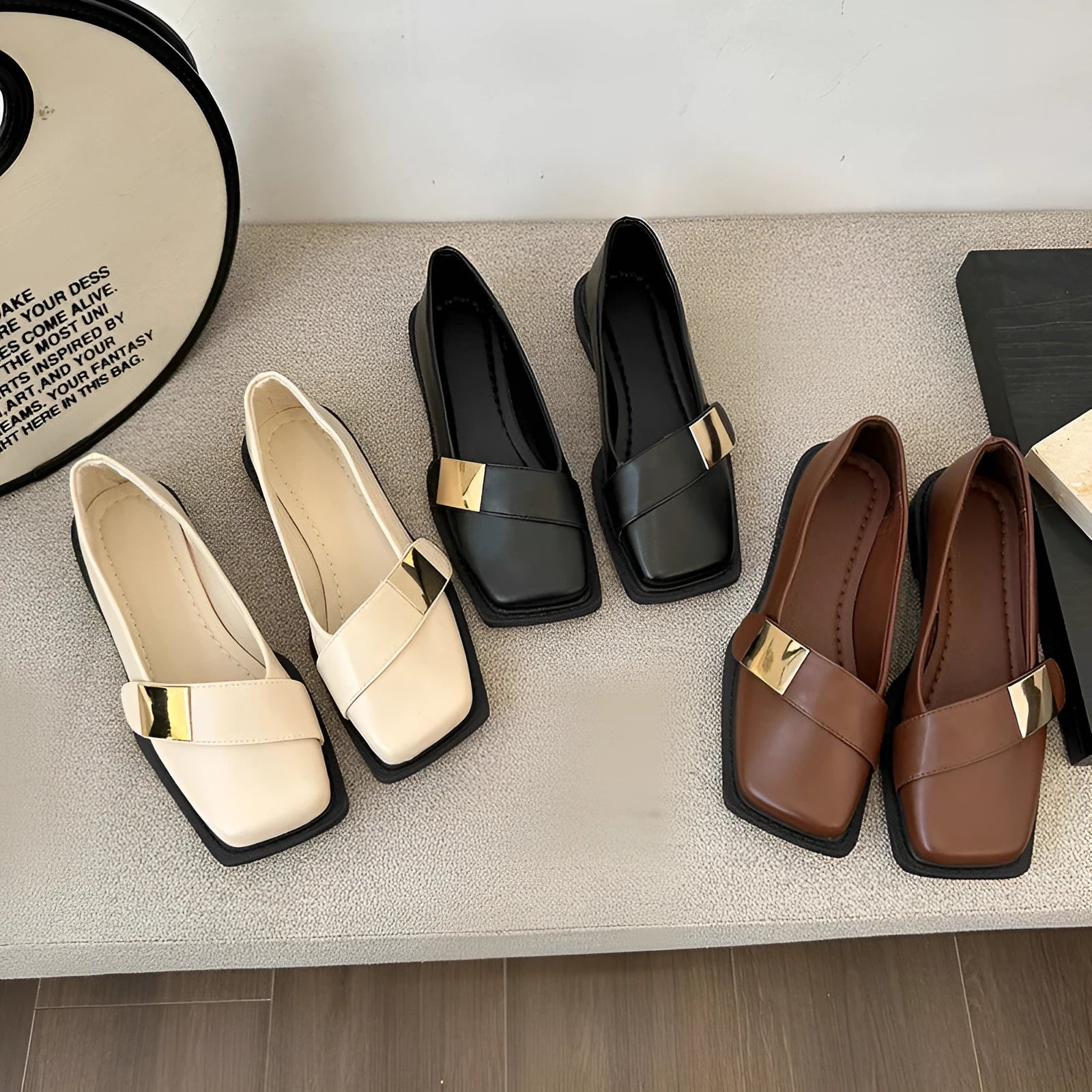 Women's beige artificial leather flat-heeled shoes with square toe and silver metal buckle.