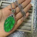 Emerald green artificial chalcedony lucky pendant necklace with stainless steel box chain on neutral background