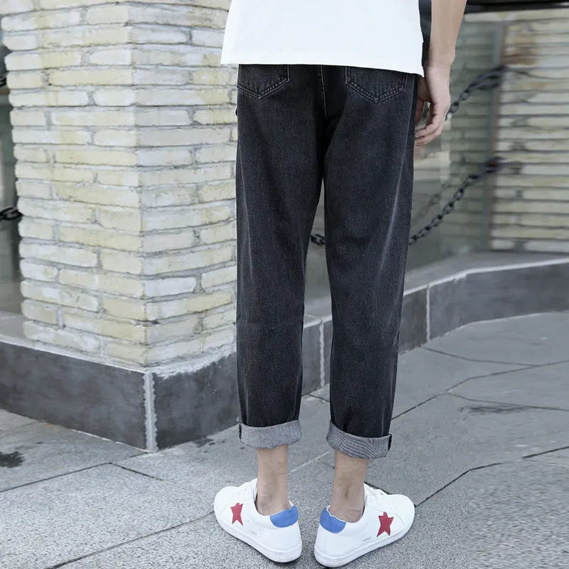 Men's black loose straight cotton jeans with harem-style fit on hanger