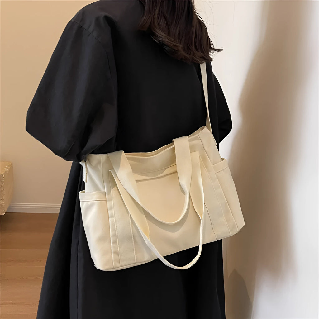 Large canvas shoulder tote bag in solid colour with sandwich pocket organisation