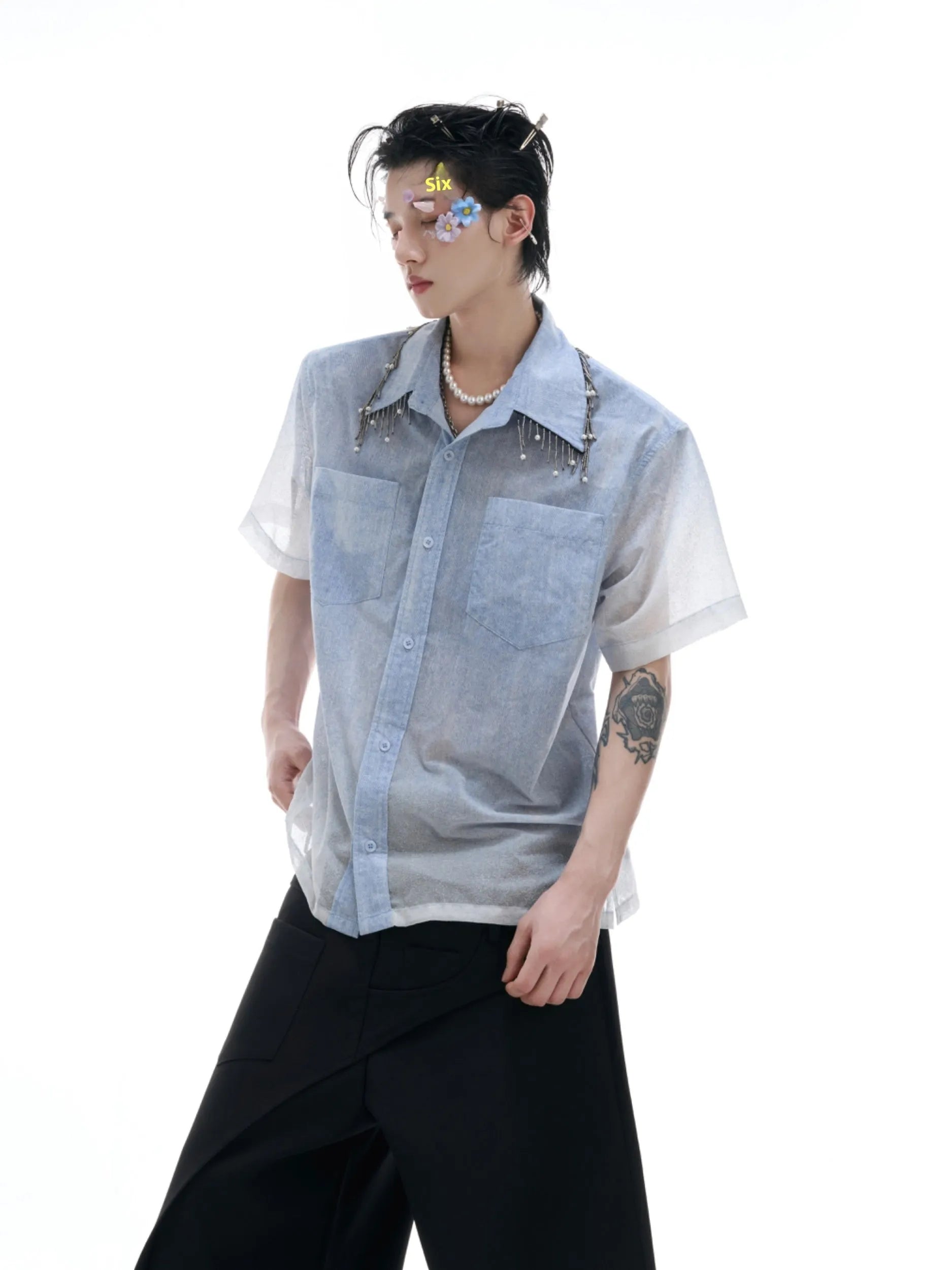 A blue and white gradient loose short-sleeve shirt on a hanger.