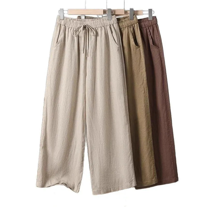 Women's straight-leg casual trousers in apricot colour with an elastic waistband and lace-up drawstring detail.