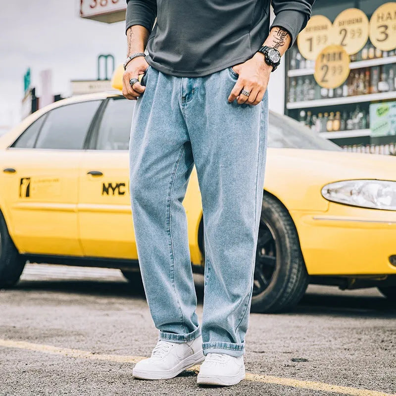Men's loose straight cotton jeans in dark blue colour showing mid waist and zipper fly design