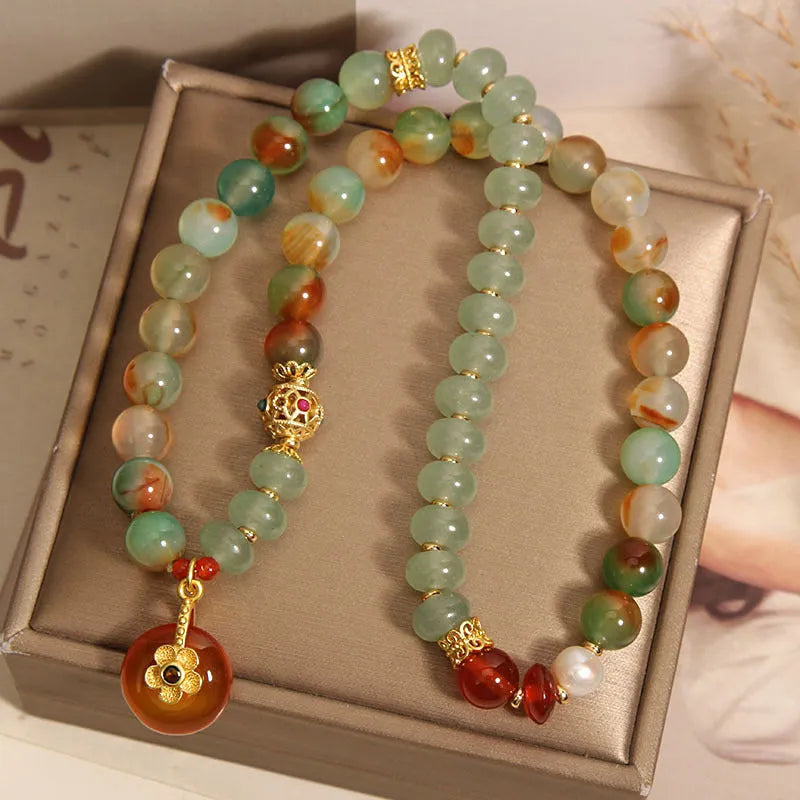 Peacock green agate double ring bracelet for women with safety buckle closure on wrist.