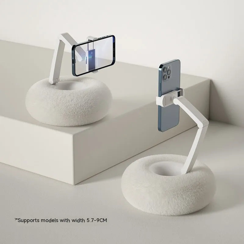 Adjustable rotating bracket holding a tablet on a desk, showing vertical lift and clamp mechanism.